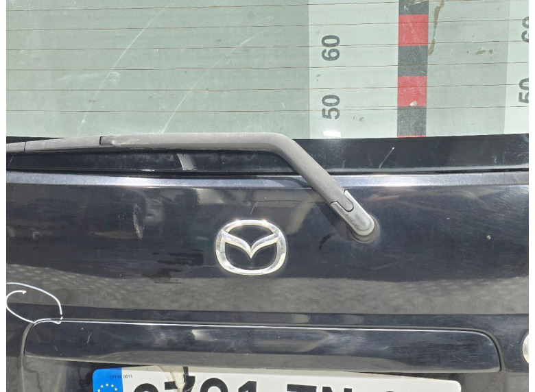 Накладка подсветки номера к Mazda Demio, 2000г.