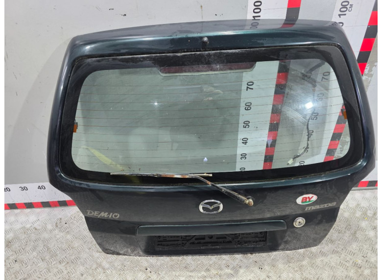 Накладка подсветки номера к Mazda Demio, 1999г.