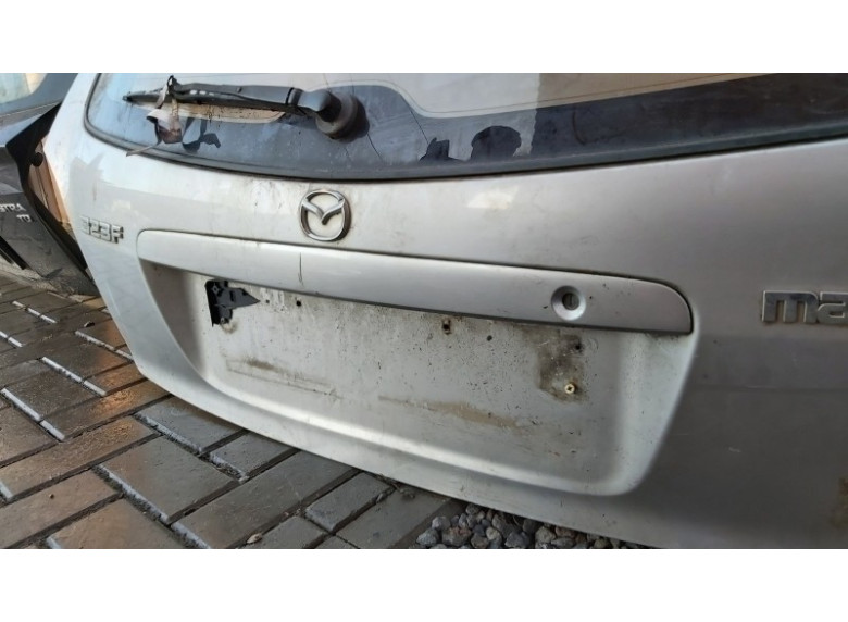 Накладка подсветки номера к Mazda 323, 2000г.